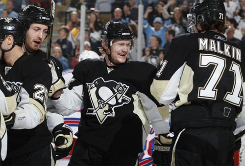 Matt Cooke celebrates with teamates after his 1st period goal