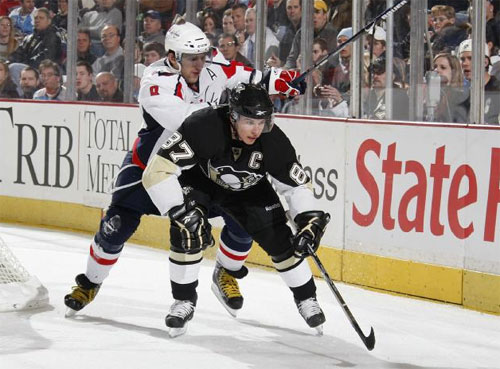 Sidney Crosby battles with Alexander Ovechkin for the puck