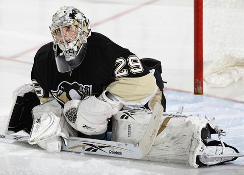 Goaltender Marc-Andre Fleury stretches before the game