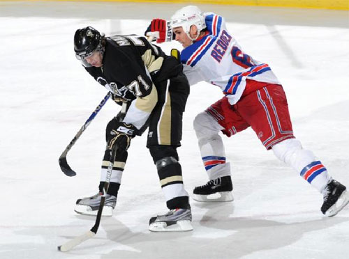 Evgeni Malkin fights off Wade Redden
